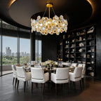 Gold chandelier above a marble table with skyline views