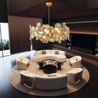 Gold chandelier over a round dark wood dining table