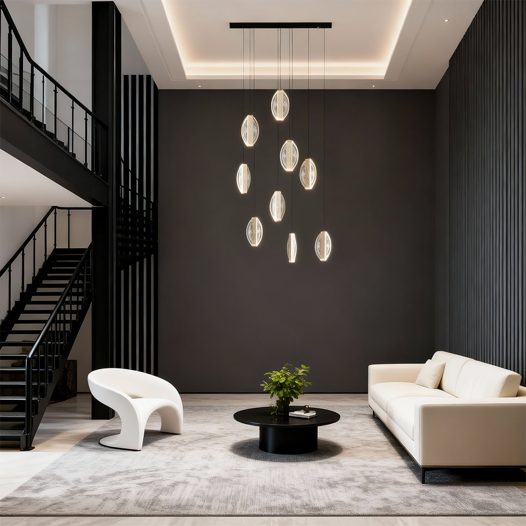 Gold mobius chandelier in a living room with dark walls