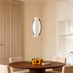 Gold mobius chandelier beside a wooden slat dining wall