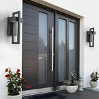 Grey and black outdoor sconce on a modern concrete wall