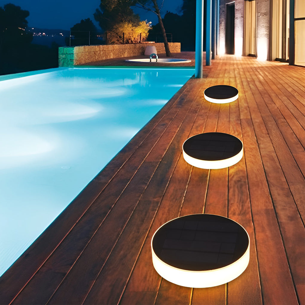 In-ground solar lights softly lighting a stone walkway