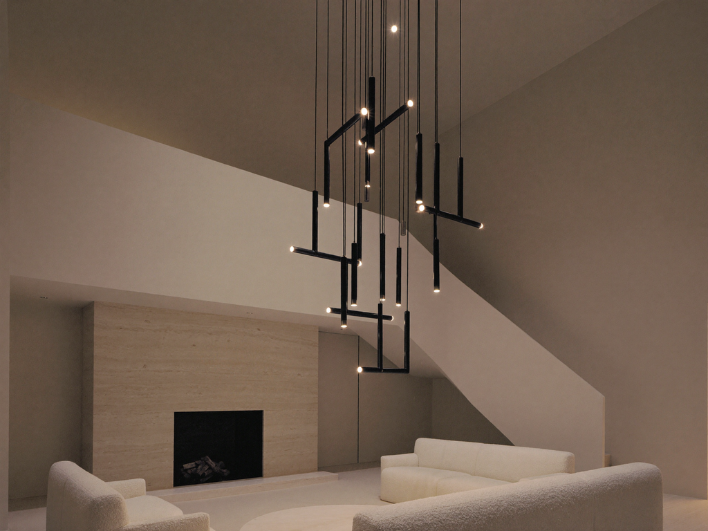 Vertical cascade chandelier in a double-height living room with travertine fireplace