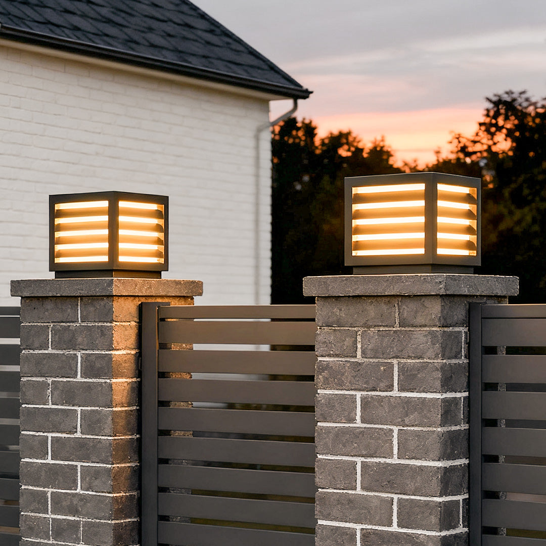 Modern LED pillar post light lighting a garden driveway