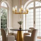 Gold island chandelier hanging above a cylindrical table