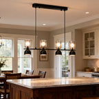 Linear glass pendant chandelier above a modern kitchen island
