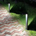 Black L-shaped path light giving ambient light in a garden
