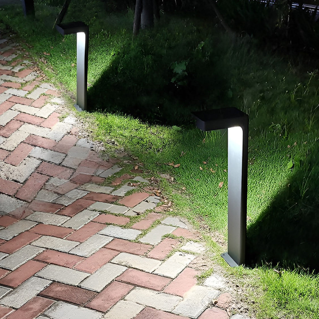 Black L-shaped path light giving ambient light in a garden