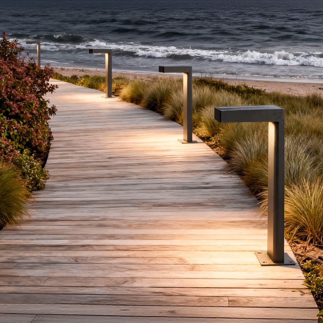 L-shaped path light casting warm light on a wooden boardwalk