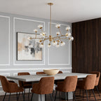 Frosted globe chandelier in a dining room beside a window