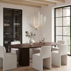 Large tiered silver mesh chandelier above a dark wood oval table