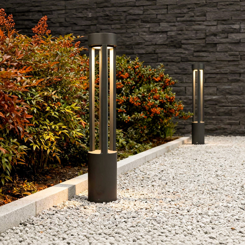Front view of LED bollard path lights on a garden walkway