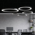 Sleek LED ring pendant light above a contemporary dining table