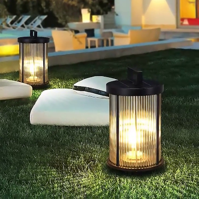 Cylindrical solar lantern casting soft warm light in a garden