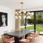 Linear chrome chandelier with clear crystal orbs in a dining room