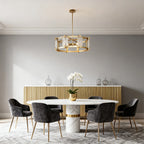 Geometric gold frame chandelier above a sophisticated dining table