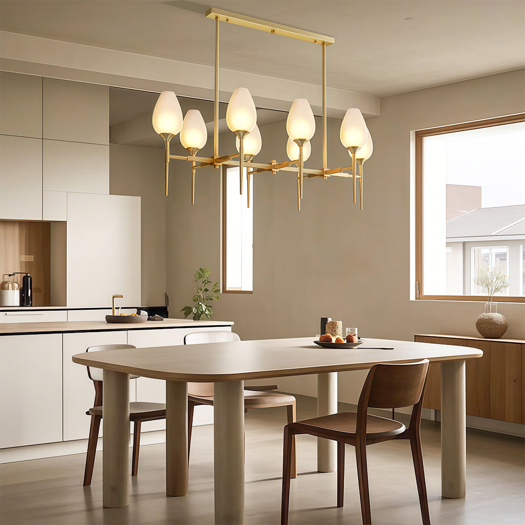Glass chandelier hanging above a modern dining table