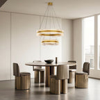 Dual ring circular chandelier hanging above a dining table