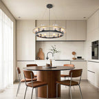 Wagon wheel chandelier over a round table in a minimalist kitchen