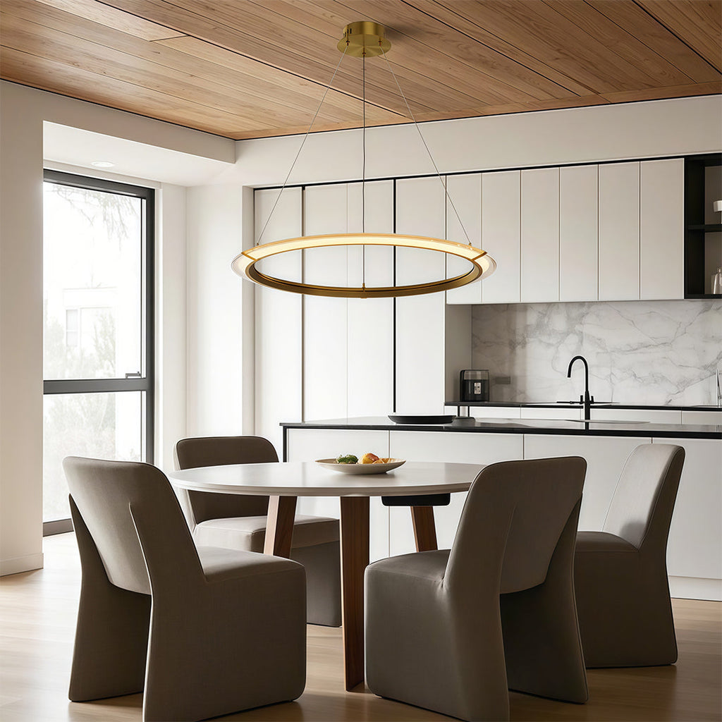Gold finish round chandelier warming a modern dining room