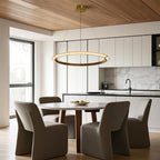 Gold finish round chandelier warming a modern dining room