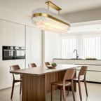 Industrial chandelier in a bright marble kitchen dining space