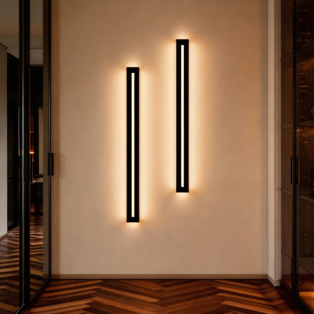 Pair of long black wall sconces lighting a hallway