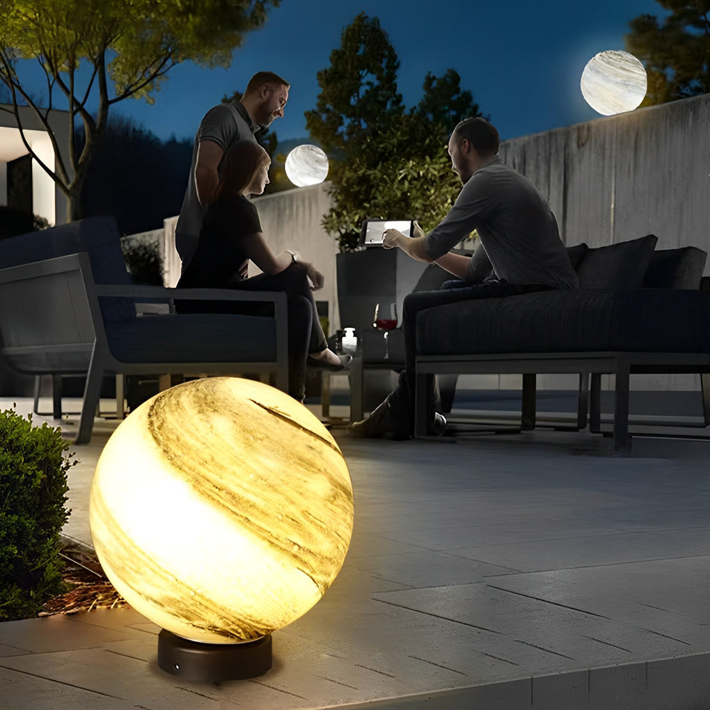 Marble globe pillar lights outside a modern house at night
