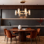 Gold metal chandelier hanging in a contemporary dining room