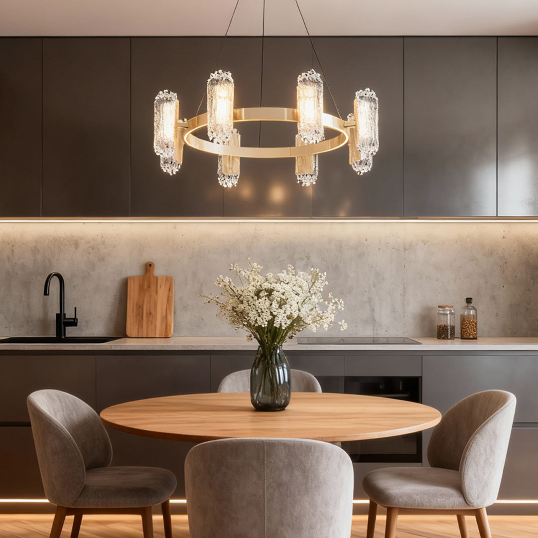 Gold metal chandelier above a marble kitchen island