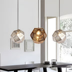 Geometric metal pendant light hanging in a dining interior