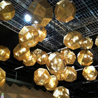 Geometric metal pendants arranged as a sculptural chandelier