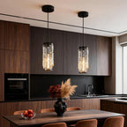 Mini crystal pendant lights hanging over a modern kitchen island