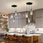 Mini crystal pendant lights over a white kitchen island