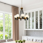 Dark bronze candelabra chandelier above a live edge table