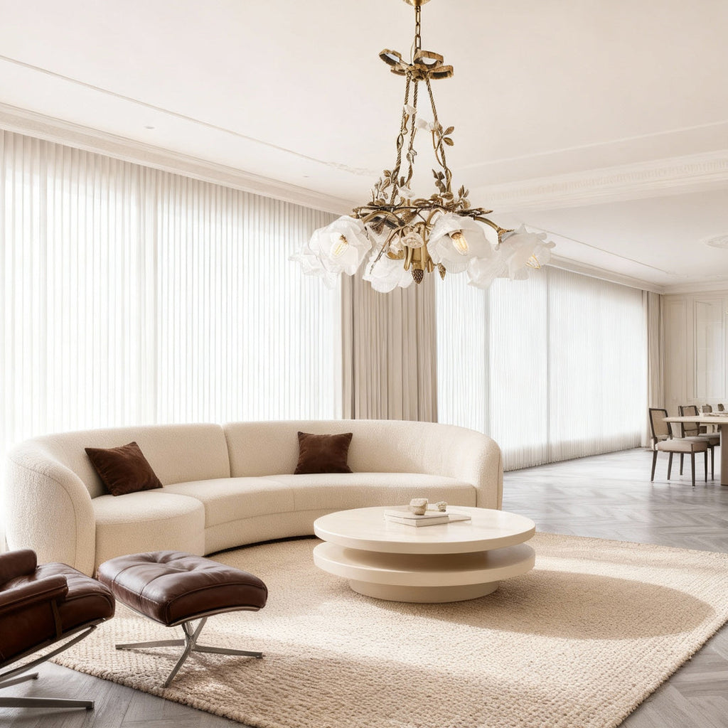 Flower chandelier above a circular coffee table in a cream room