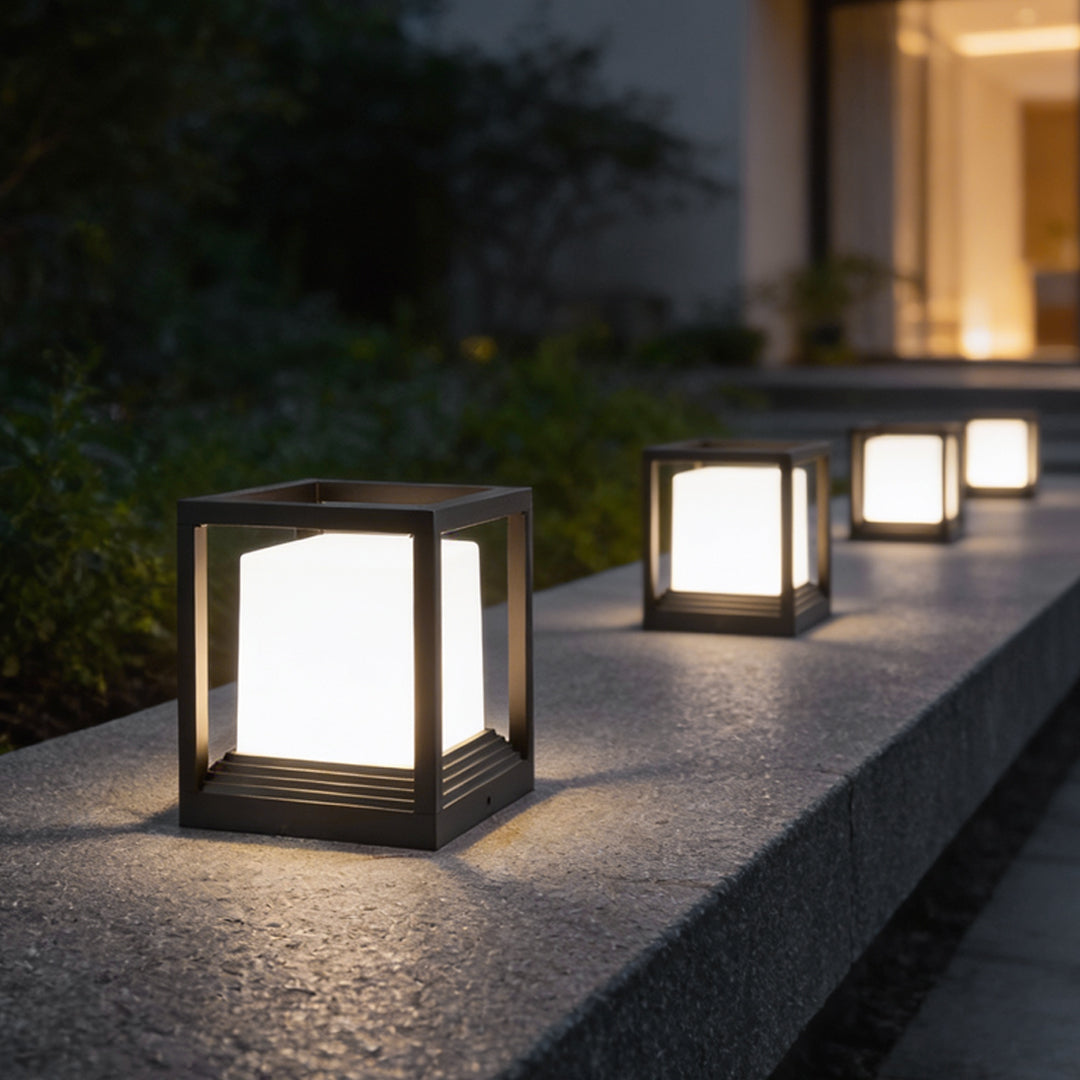Square garden pedestal lights along a poolside pathway at night