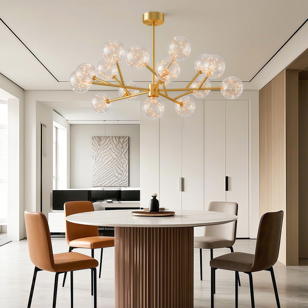 Globe chandelier hanging above rust upholstered dining chairs