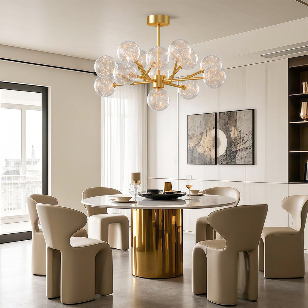 Globe chandelier above an elegant brass dining table