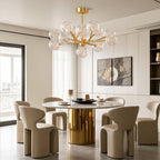 Globe chandelier above an elegant brass dining table