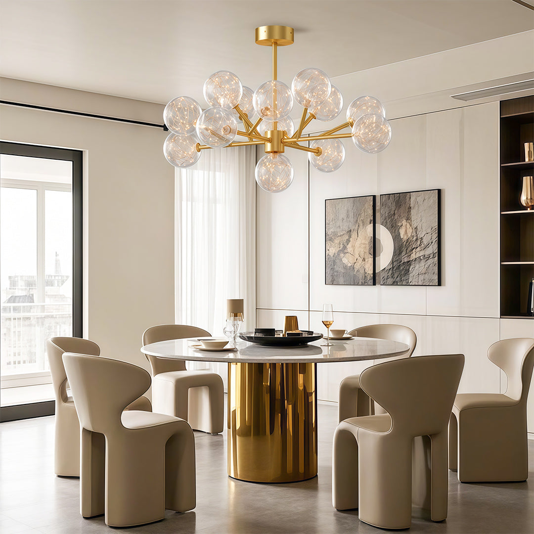 Globe chandelier above an elegant brass dining table