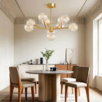 Globe chandelier above minimalist brown leather chairs