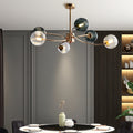 Gold branch ceiling light above a modern dining setting