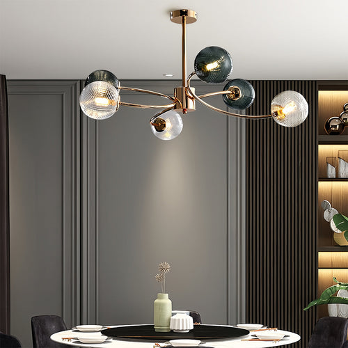 Gold branch ceiling light above a modern dining setting