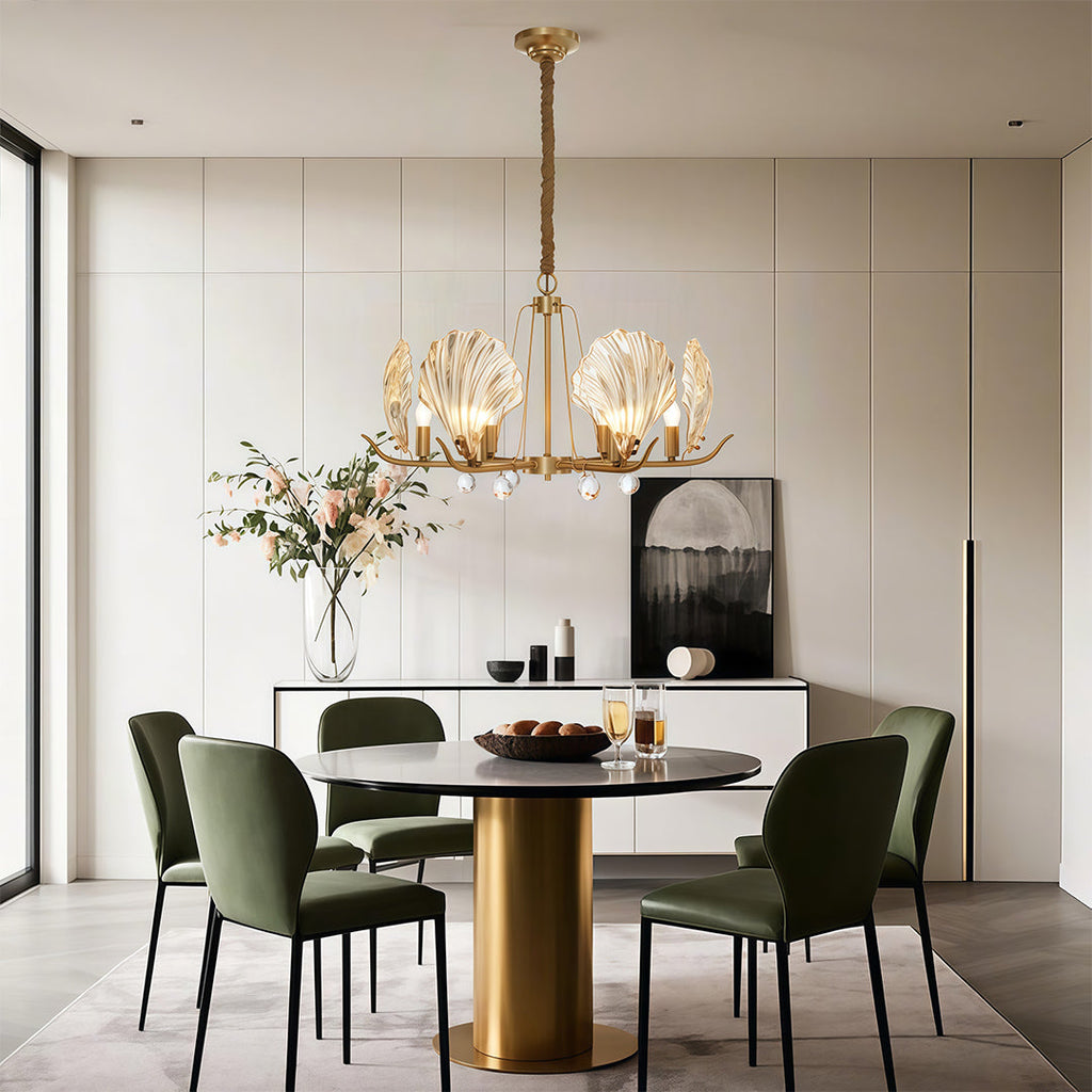 Chandelier above a contemporary dining table with green chairs