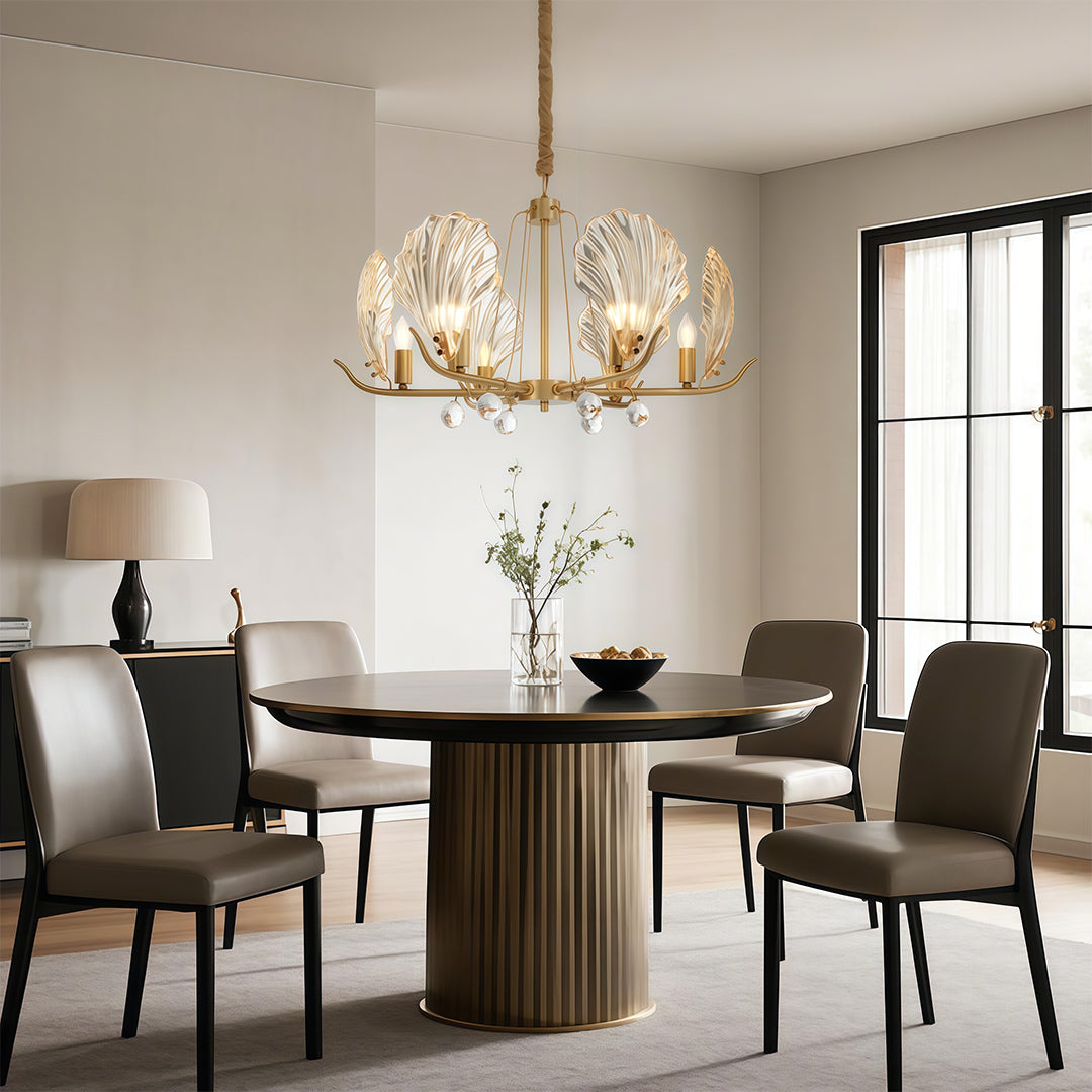 Chandelier above a fluted dining table with designer chairs