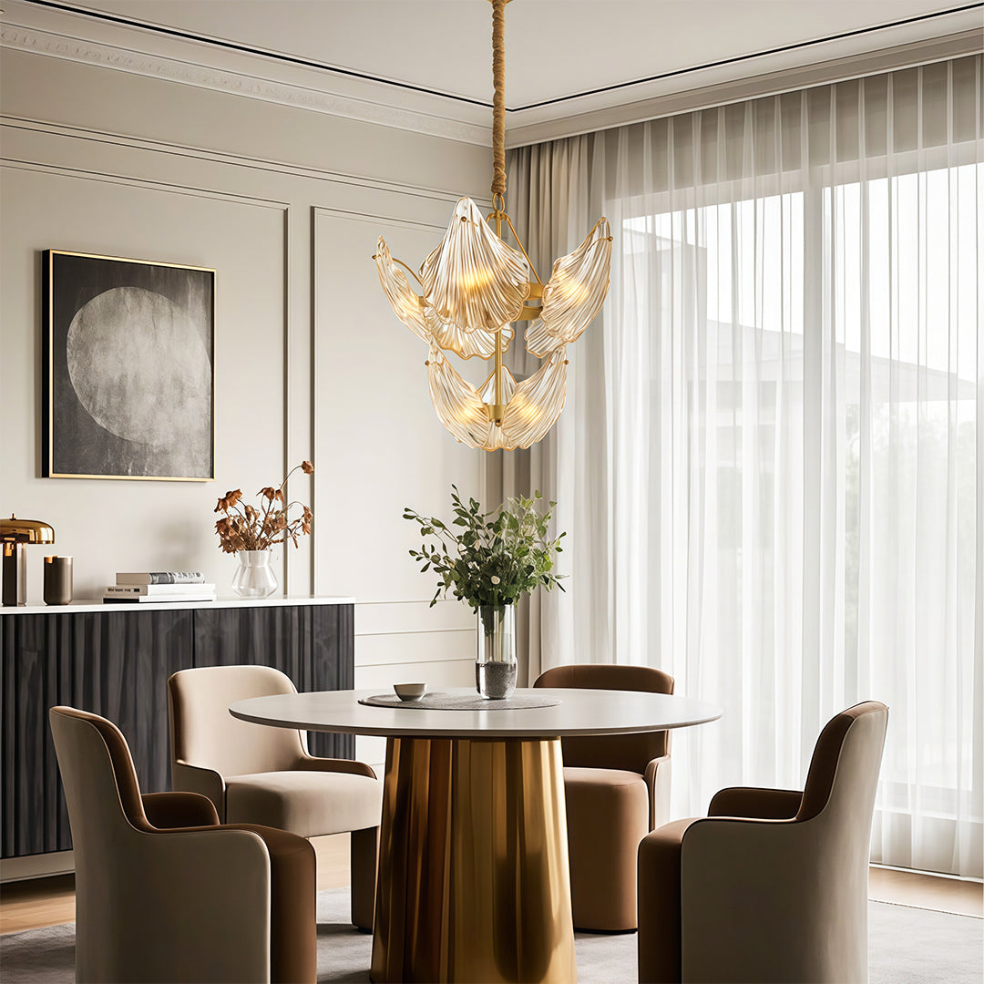 Large chandelier in a living room with a brass table