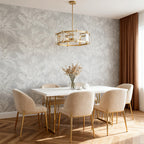 Round glass chandelier in a dining room with leaf wallpaper