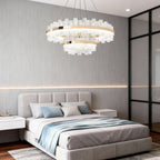 LED chandelier above a minimalist gray platform bed