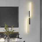 Linear wall sconces arranged geometrically on a television wall